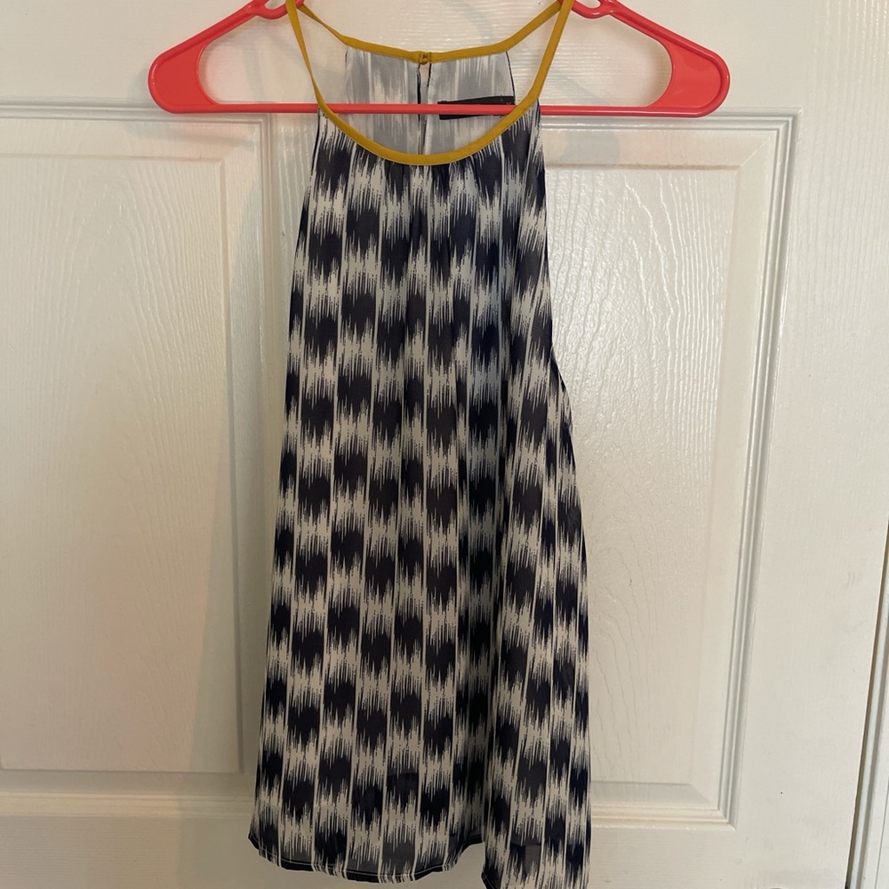 Navy and white, thin but not see through. Yellow neckline.